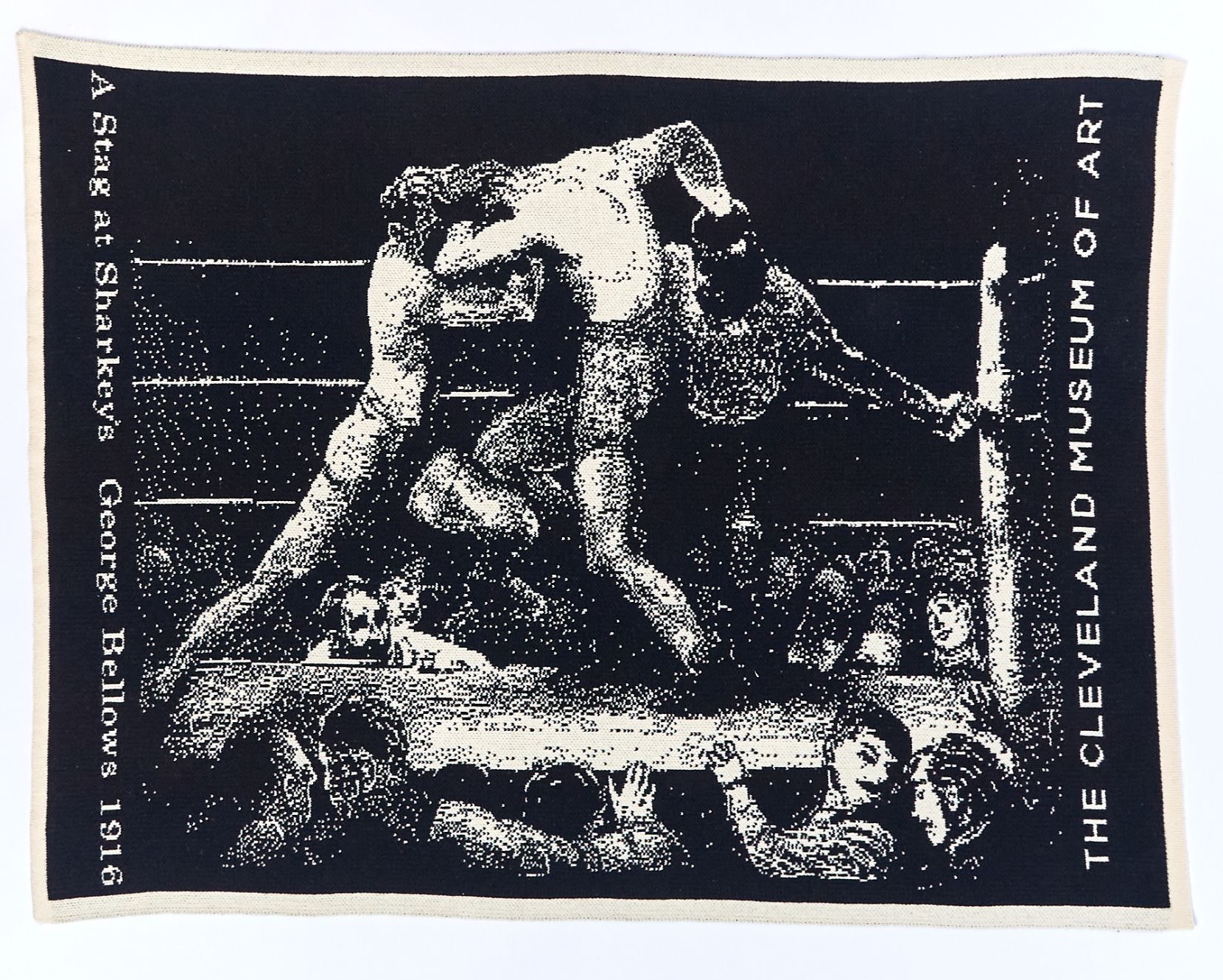 A black and ecru jacquard blanket reproducing George Bellows' A Stag at Sharkey's as knitted halftone, with the title up one edge and The Cleveland Museum of Art down the other